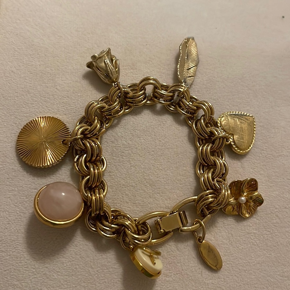 Gold charm bracelet with pink accents